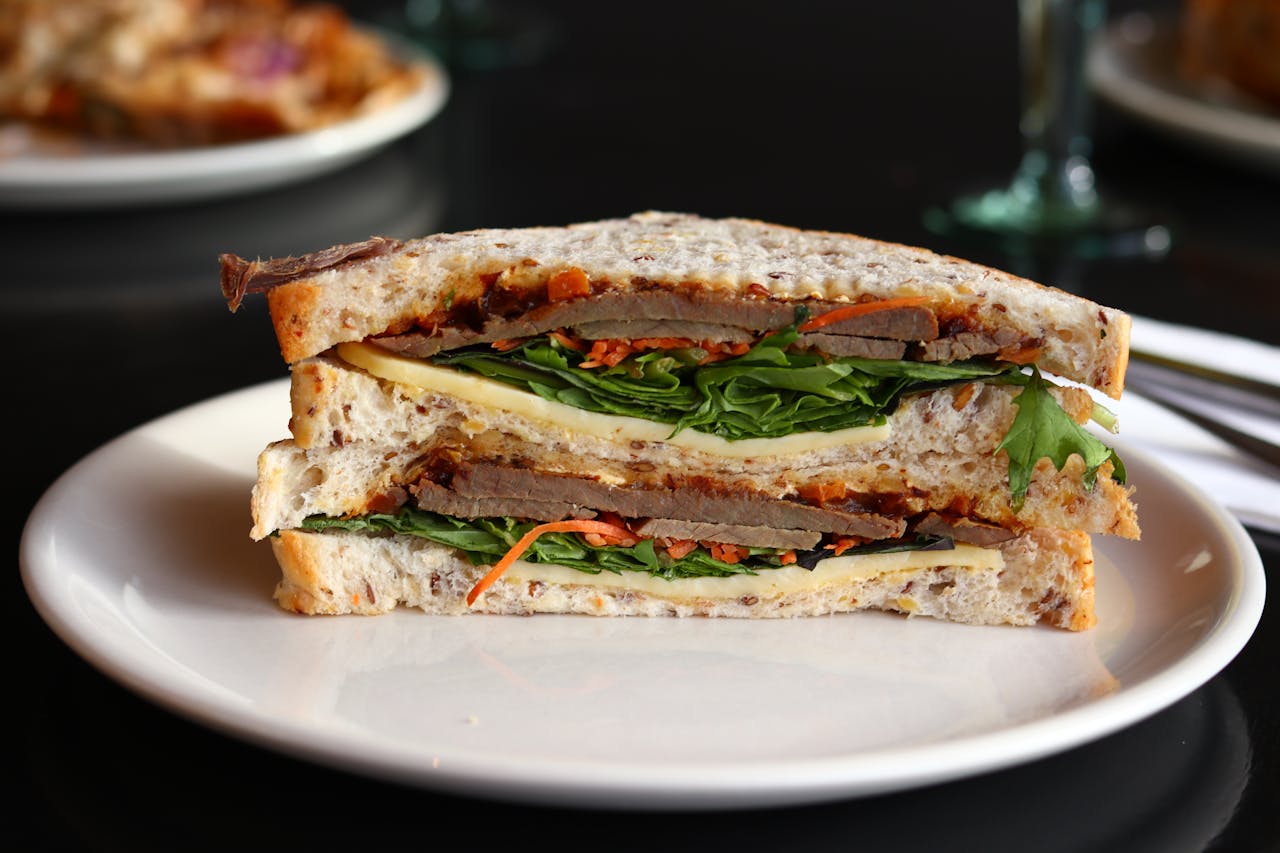 <p> Sandwiches are the perfect meal for any time of day. Whether you’re having a classic PB and J, a deli sandwich stacked with meats and cheeses, or a fancy club sandwich with all the trimmings, sandwiches are versatile and satisfying. They’re easy to make, portable, and can be customized to fit any taste or dietary preference. Whether you’re enjoying a quick lunch at home or grabbing a sandwich from your favorite café, sandwiches will always be a food we turn to, no matter how much money we make. </p> :: Pexels