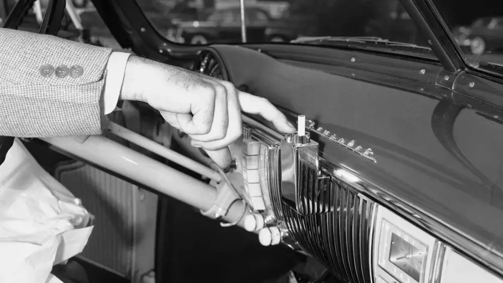 <p> At one time, nearly every car came equipped with a built-in ashtray and a cigarette lighter. These features were a reflection of the high smoking rates in past decades and were standard in both luxury and economy vehicles. The cigarette lighter also doubled as a power source for small devices, a function that later evolved into the 12V accessory socket. As smoking rates declined and car interiors became more refined, manufacturers removed ashtrays and lighters in favor of cup holders and USB charging ports. Today, if a driver wants an ashtray, they must purchase a portable one separately. </p> :: gomechanic.in
