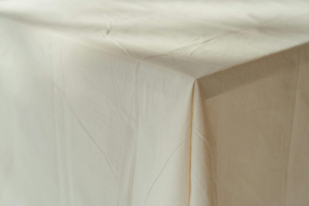 <p>A tablecloth does wonders. It hides an old or ugly table and creates an instant upgrade. Choose a neutral color or a fun pattern, depending on your style. It doesn’t have to be fancy—linen-look fabrics are easy to find and give that high-end feel. Plus, spills are less stressful when your table is covered. A clean, fresh tablecloth also makes your dishes pop, turning simple meals into a feast.</p> ::Pexels