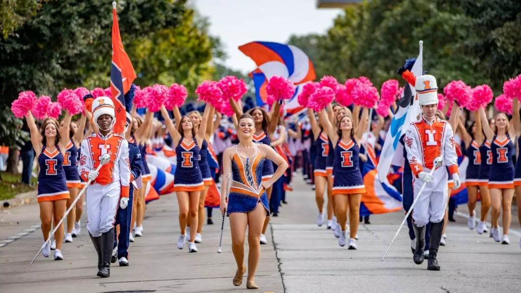 <p> Homecoming used to be a full-blown community affair—complete with parades, floats, marching bands, and pep rallies that brought everyone together, from alumni to current students to town residents. These celebrations were about more than school spirit; they reinforced the bond between a school and its community. However, budget cuts, changing school cultures, and shifting priorities have led to the downsizing or cancellation of many homecoming traditions. What was once a vibrant celebration of unity and pride is becoming a quiet week of private events and formal dances. </p> :: Illinois Athletics