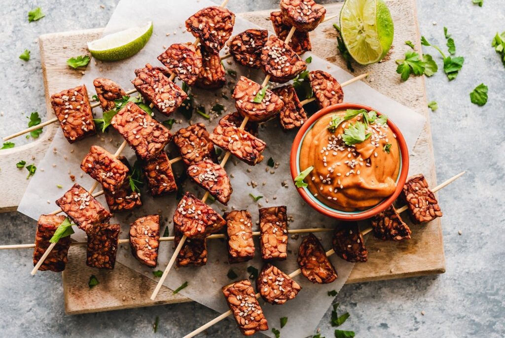 <p> If tofu is smooth jazz, tempeh is punk rock. Made from fermented soybeans, tempeh has a chewy texture, nutty flavor, and a protein content that blows most plant foods out of the water—about 21 grams per 3.5-ounce serving. It also supports gut health thanks to its natural probiotics. Tempeh can be sliced, crumbled, or cubed and works wonders in sandwiches, grain bowls, stir-fries, or tacos. Marinate it to soak in flavor, or steam it first to mellow the taste. Once you get the hang of it, tempeh will become your go-to for a hearty, meat-like bite with serious nutritional credentials. </p> :: Pexels