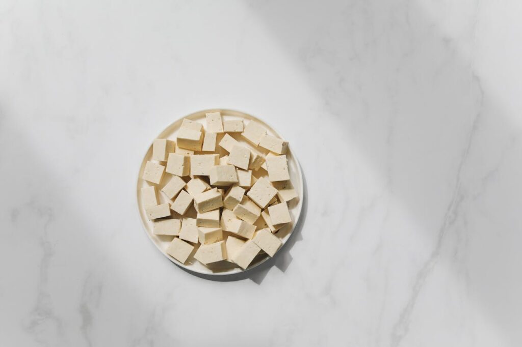 <p> Tofu might just be the most misunderstood food in the plant-based world. Made from soybean curds, tofu contains about 10 grams of protein per half-cup serving, and it’s a blank canvas for flavor. Depending on the type—silken, soft, firm, or extra-firm—you can bake it, pan-fry it, blend it, or grill it. With the right seasonings and cooking techniques (hint: press it first to remove excess water), tofu transforms into everything from crispy stir-fry cubes to creamy sauces or even desserts. It's also a great source of calcium and iron—especially if it’s fortified. </p> :: Pexels