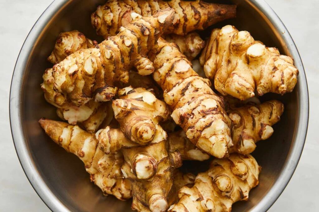 <p> Despite the name, Jerusalem artichokes are not artichokes at all. These tuber-producing members of the sunflower family are a crunchy, nutty delight. Hardy in zones 3 through 9, sunchokes are easy to grow and thrive with very little attention. Once you plant them, they’ll multiply underground and can be harvested in late fall. Eat them raw in salads or roast them for a sweet, earthy side dish. A word of caution: like horseradish, they tend to spread, so container growing or designated garden areas are best. </p> :: allrecipes.com