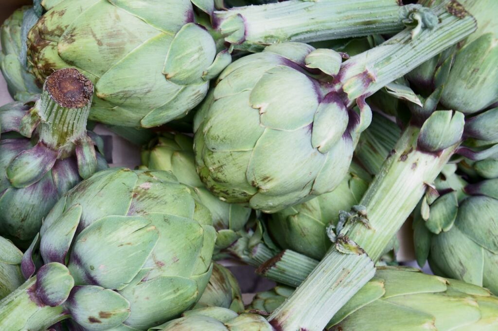 <p> Artichokes are more than just pretty faces—they’re bold, delicious, and surprisingly easy to grow in the right zones. Hardy in USDA zones 7 through 11, these edible flower buds add a dramatic flair to your garden with their spiky foliage and striking purple blooms. Varieties like ‘Imperial Star’ even thrive in cooler climates if given winter protection. Once established, artichokes return each year with minimal upkeep. Roast the hearts, dip the leaves, and enjoy the beauty they bring to your backyard. </p> :: Pexels