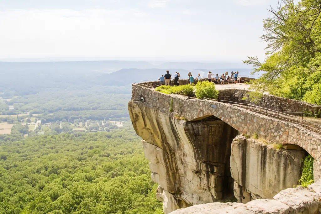 <p> Rock City is one of those places that blends nature with just enough whimsy to make you smile. Located near Chattanooga, it features towering rock formations, blooming gardens, and pathways that are easy to navigate. The highlight is Lover’s Leap, where you can stand on a scenic overlook and see seven states on a clear day. Along the way, you will also find fun little details like gnome statues tucked among the rocks. It is a lighthearted trip that is as much about the journey as the destination. </p> :: DALL-E