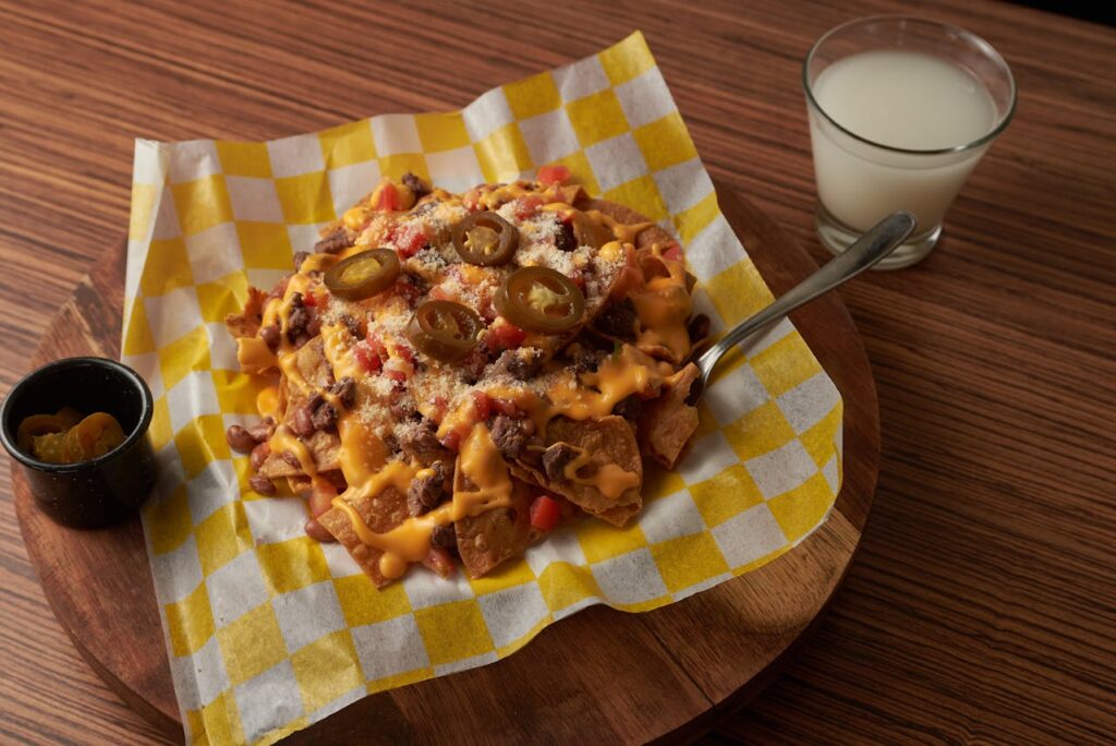 6. Loaded Nachos Straight from the Oven <p> Loaded nachos are one of those dishes that instantly feel exciting when they hit the table. The melted cheese, the layers of toppings, and the mix of colors all make it hard to resist. The smell alone is enough to draw people in. When you grab a chip, you get that crunch followed by warm, gooey toppings that create a satisfying contrast. Adding fresh ingredients like tomatoes or herbs brings a bit of brightness that keeps the dish from feeling too heavy. The key is serving them right away while everything is still hot and slightly bubbling. That freshness is part of what makes the experience so enjoyable. </p> :: Pexels