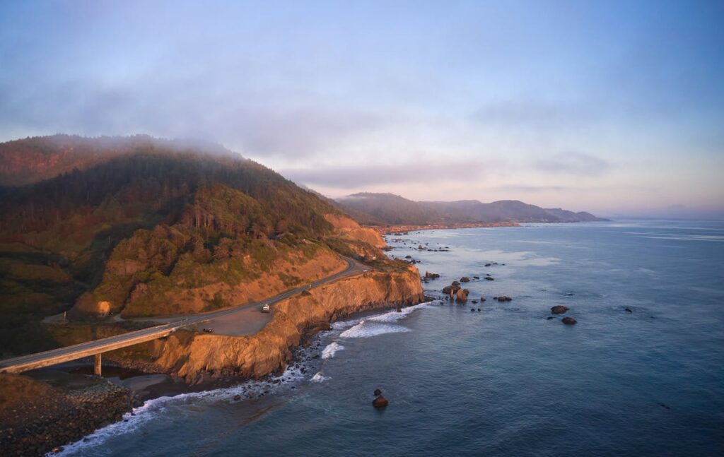 <p> Driving along the Pacific Coast Highway feels like stepping into a movie you do not want to end. The road hugs the edge of the coastline, giving you constant views of the Pacific Ocean crashing against rugged cliffs. Starting in San Francisco and heading toward Los Angeles, the route is packed with highlights like the dramatic curves of Big Sur and the iconic Bixby Creek Bridge. What makes this drive special is that it encourages you to slow down. You will want to stop often, whether it is for a scenic overlook, a quiet beach, or a small café tucked along the road. It is not about rushing through miles but soaking in every single one. </p> :: Pexels