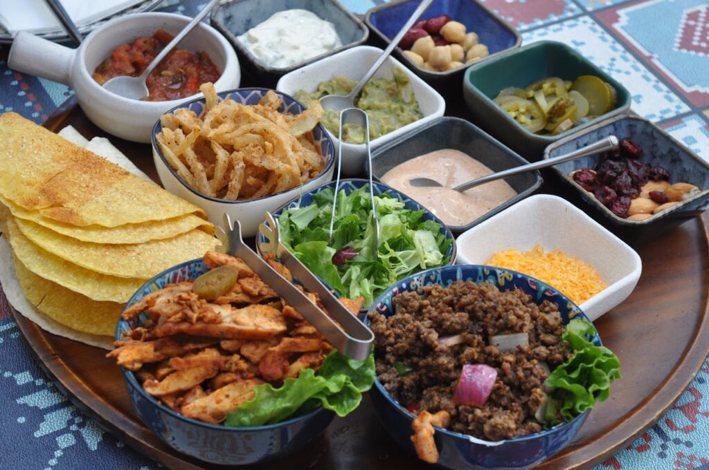 2. Build Your Own Taco Bar <p> A taco bar is one of the easiest ways to make a meal feel interactive without adding stress to your cooking routine. Instead of serving plated food, you lay everything out and let people create their own combinations. The variety is what makes it special. You have warm tortillas, savory fillings, crunchy toppings, and fresh herbs all in one place. The mix of textures keeps every bite interesting, and the colorful setup makes the table look inviting. The aroma of seasoned meat and fresh ingredients ties it all together. It is also perfect for gatherings because everyone gets exactly what they want, which means less pressure on you as the host. </p> :: Pexels